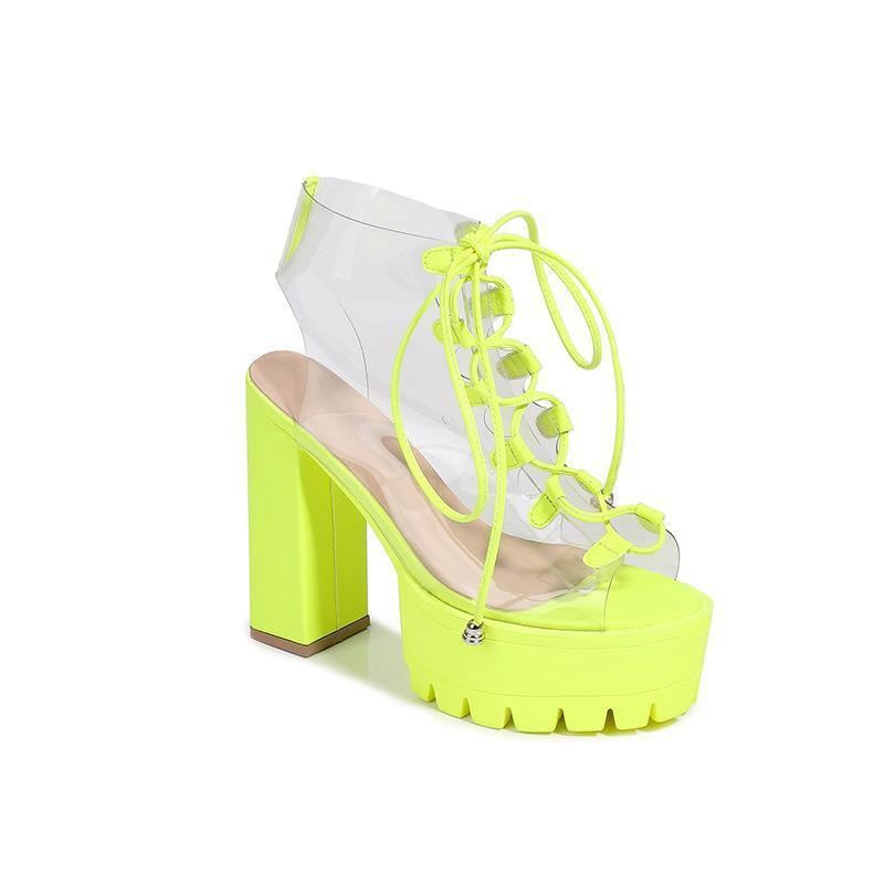 Neon yellow high heel sandals with transparent straps and chunky platform soles, perfect for trendy occasions.